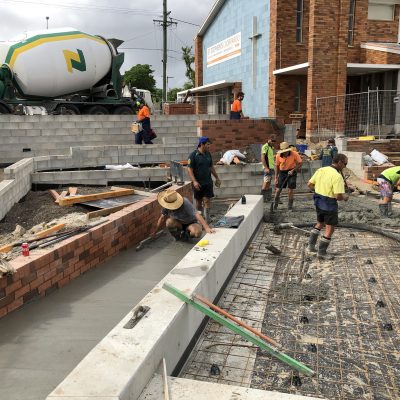 Concrete slabs being poured in the courtyard